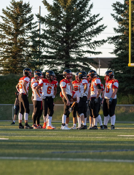 Rebels players gathered on the field
